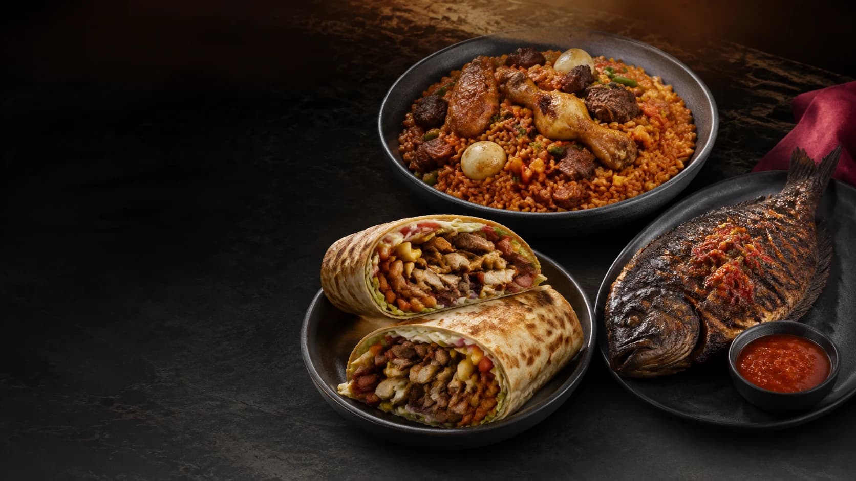 A spread of assorted jollof, loaded shawarma and grilled tilapia from Adee’s Food.