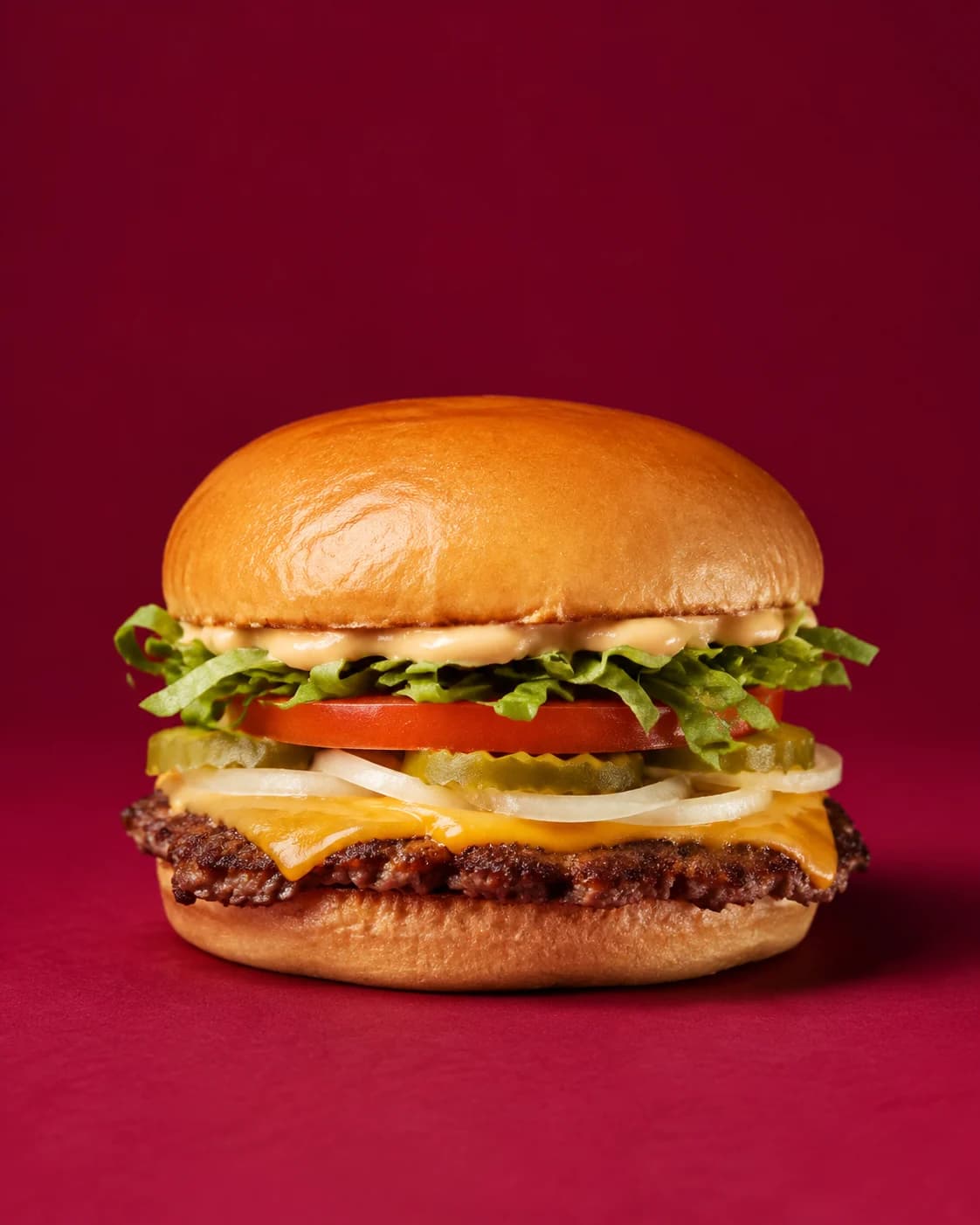 Single smash beef burger with cheddar, lettuce, tomato, pickles, onion and special sauce.